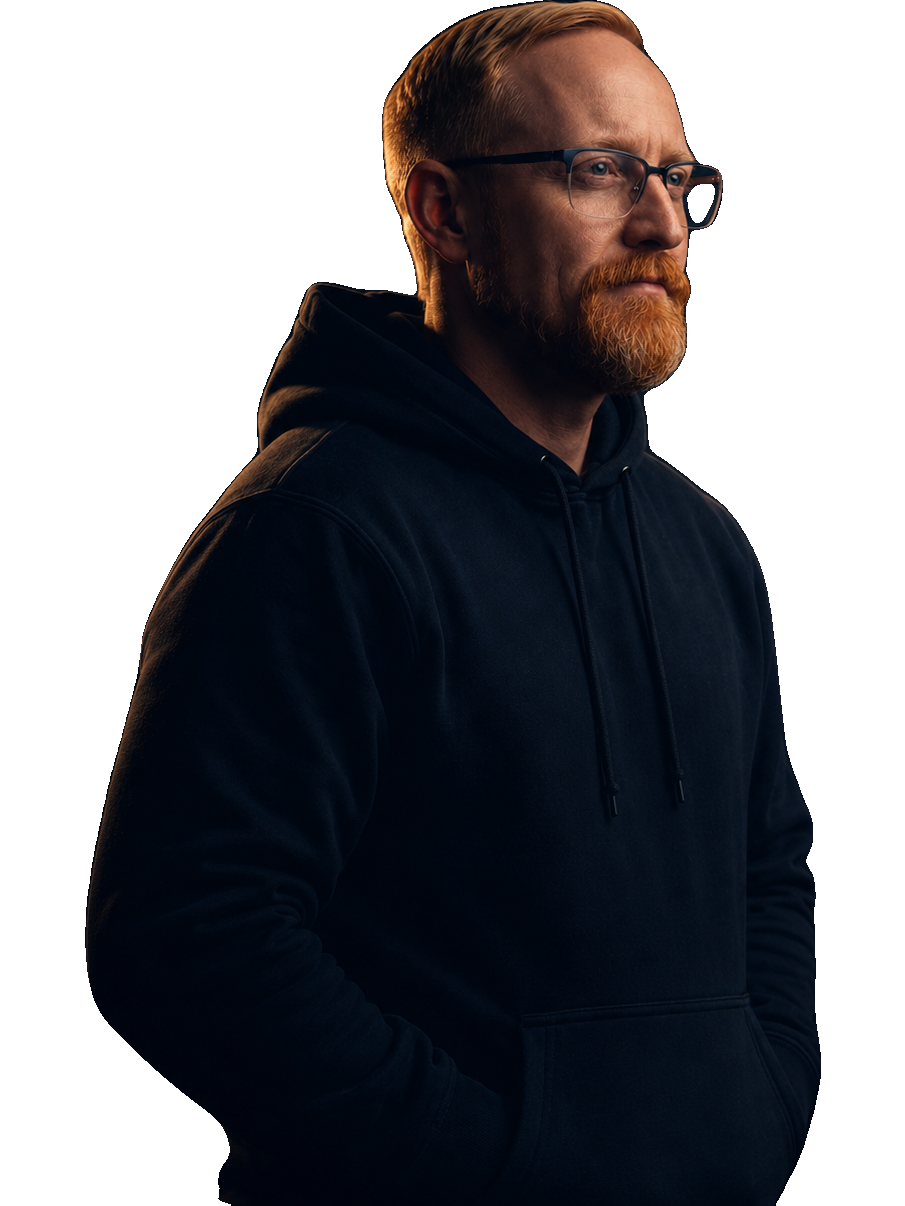 Cinematic side-profile portrait of Ben Potter in a dark hoodie